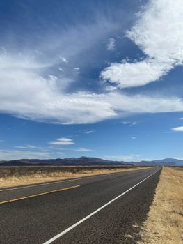 Vast landscape of Valentine, Texas with an expansive road and stunning sky.