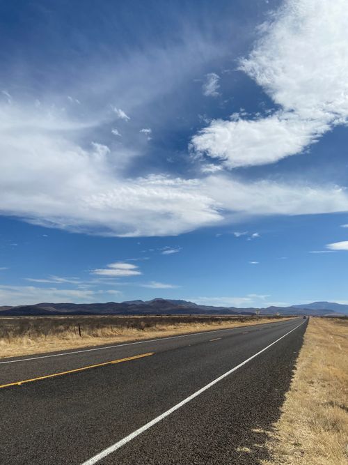 Free Vast landscape of Valentine, Texas with an expansive road and stunning sky. Stock Photo