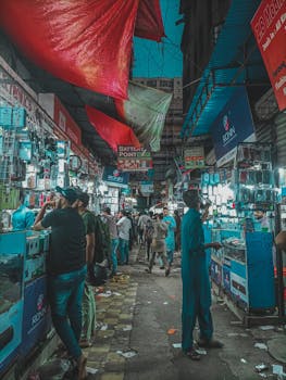 Vibrant market scene at night with colorful canopies, bustling crowd, and illuminated stalls.