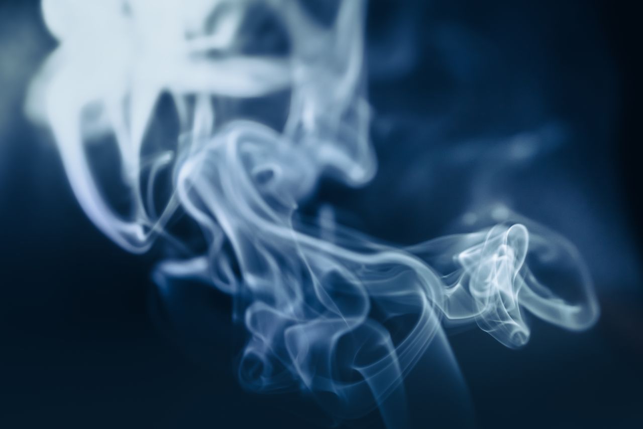 abstract close up of swirling blue smoke on a dark background