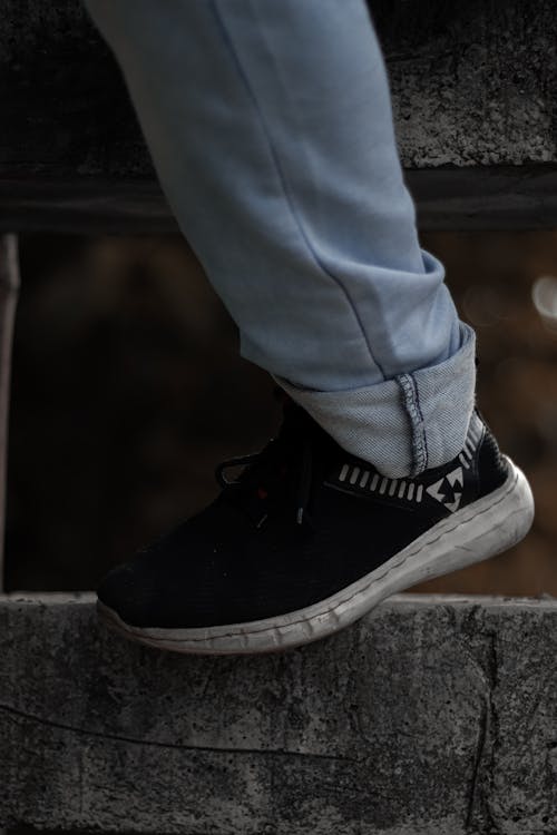 A Close-Up Person Wearing a Black Shoe