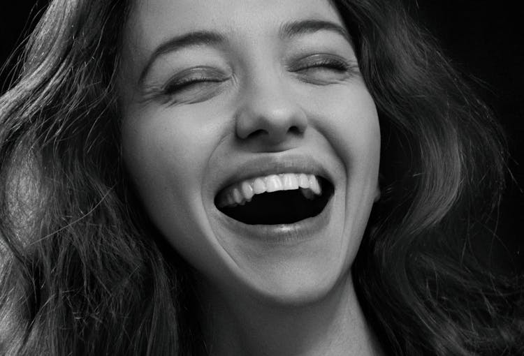 Grayscale Photo Of Woman Laughing