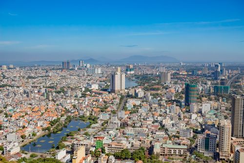 Free High-angle view of a sprawling cityscape with skyscrapers under a clear blue sky. Stock Photo