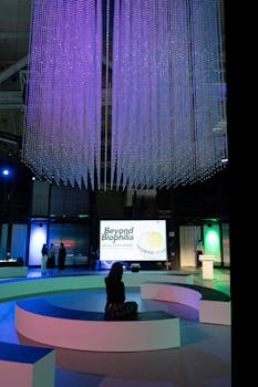 An indoor exhibition features stunning neon lighting and modern decor.