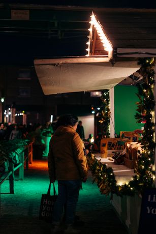 Shoppers visiting a festive outdoor winter market
