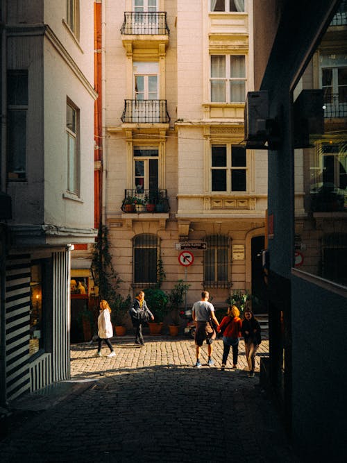 People Walking on a Cobblestone Street