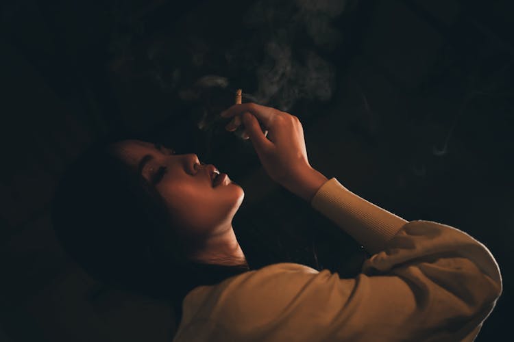 A Woman Smoking A Cigarette 