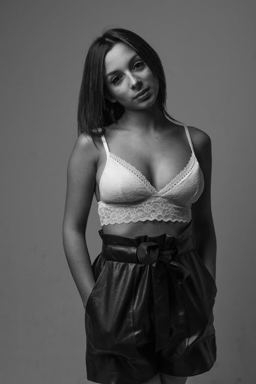Black and White Photo of a Woman Posing in a White Bra