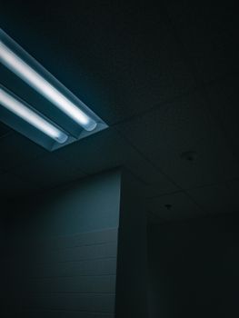 Moody interior capture of ceiling with fluorescent light, casting a soft glow.