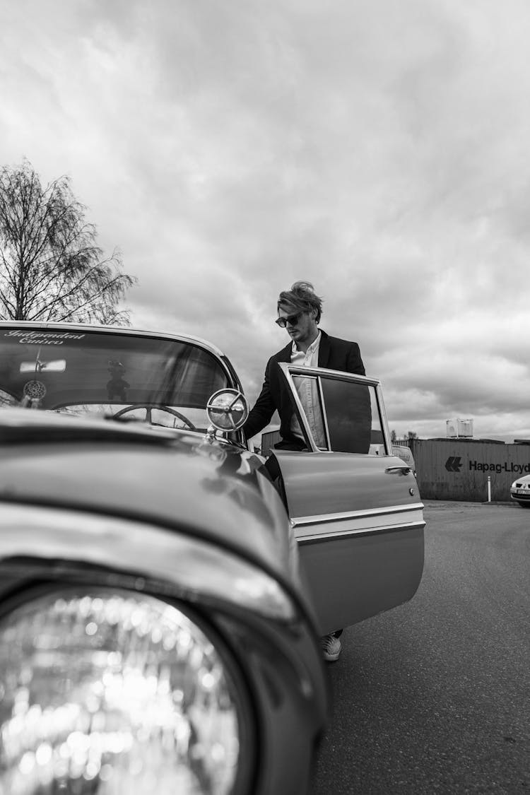 Man In Suit Entering Car