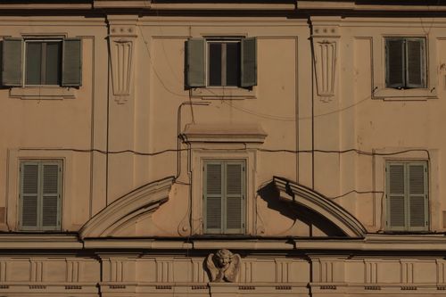 Free Close-up of a Mediterranean facade showcasing detailed cornice and shutters, exuding historical charm. Stock Photo