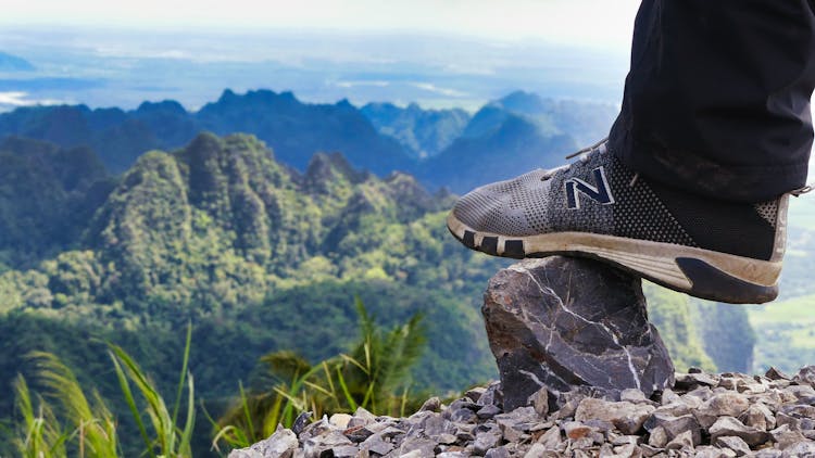 Close-Up Photo Of Person Stepping On A Rock