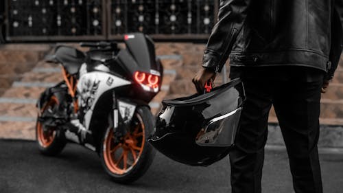 Man Wearing Leather Jacket in Front of a Motorbike 