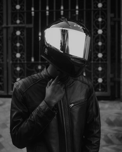 Grayscale Photo of Man in Black Leather Jacket Wearing Helmet