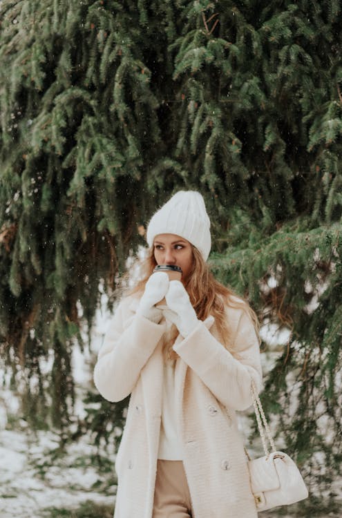 Blonde Woman in Coat under Tree in Winter · Free Stock Photo