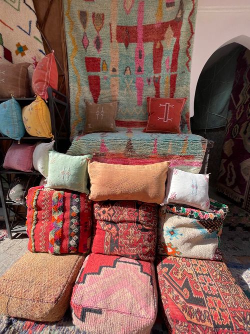 Free Vibrant Moroccan textiles and cushions on display in a Marrakesh market. Stock Photo