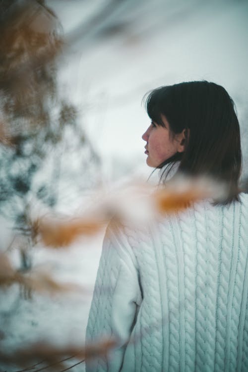Back View of a Woman in a White Sweater