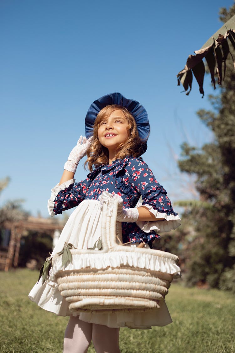 Photo Of A Young Girl Carrying A Basket