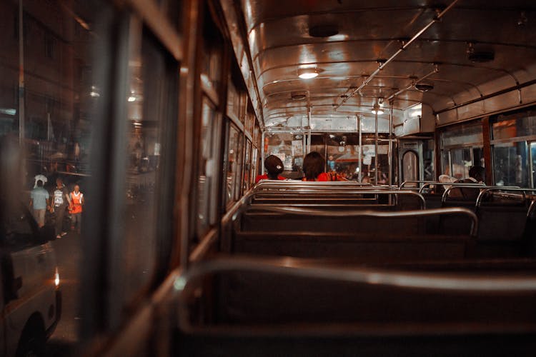 Back View Of People Riding A Bus 