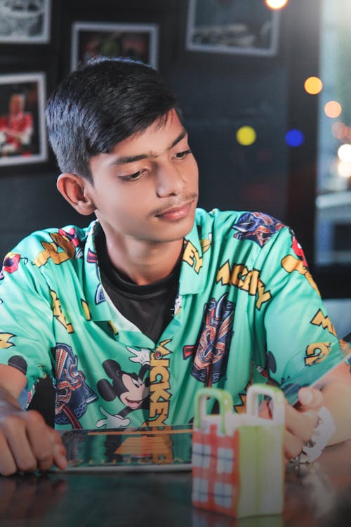 Boy Is Waiting For Order In Restaurant