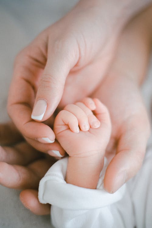 Close-up of Parents and Child Hands