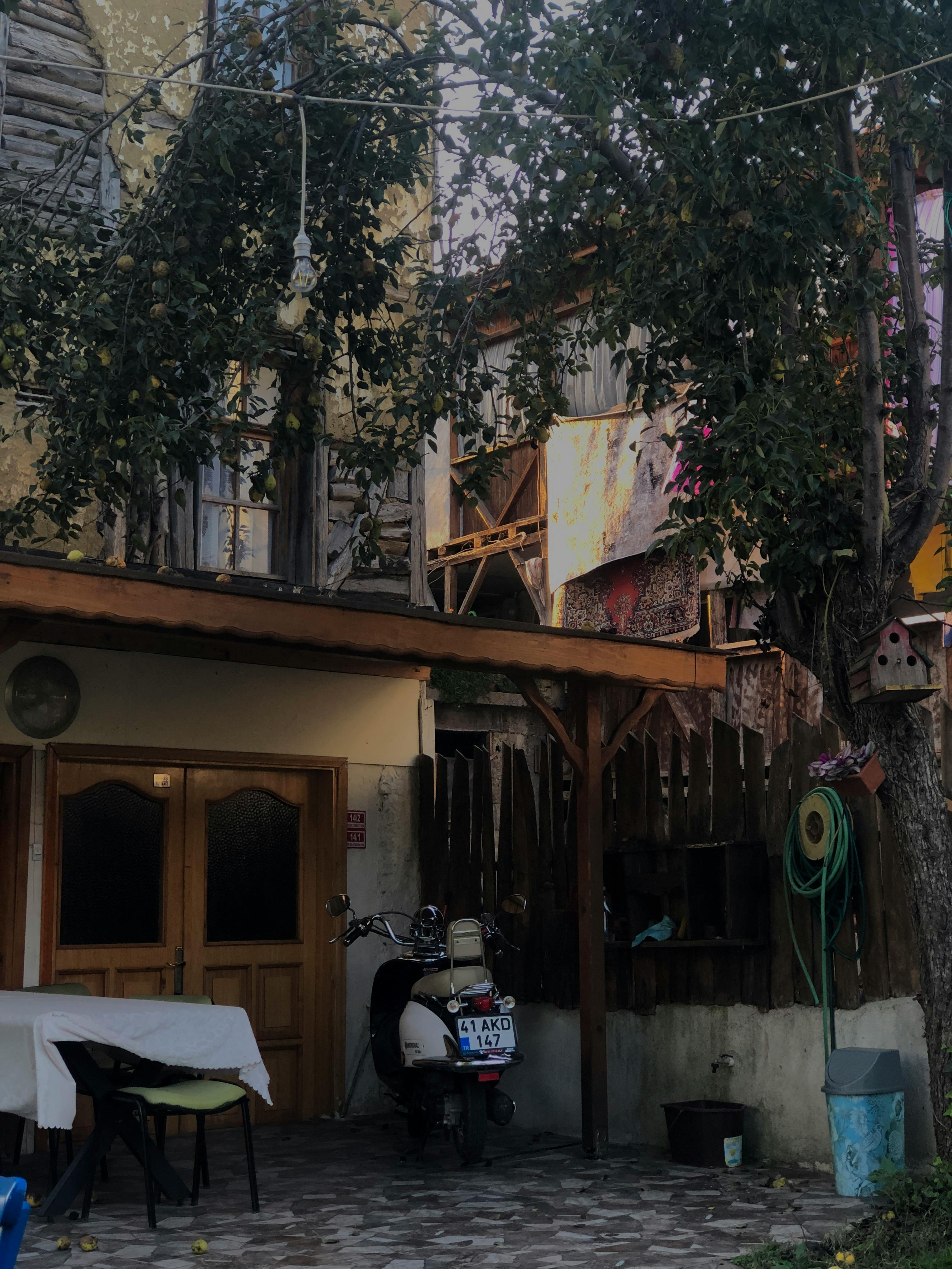 A Parked Moped in Front of House · Free Stock Photo