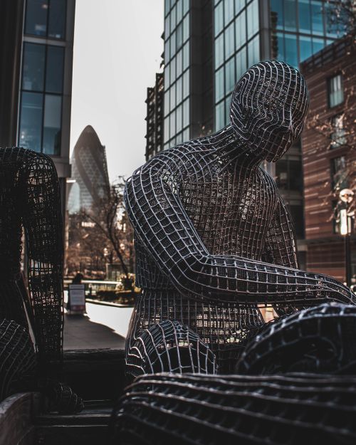 Free Wire sculpture with London's modern skyscrapers, showcasing urban art against iconic architecture like The Gherkin. Stock Photo