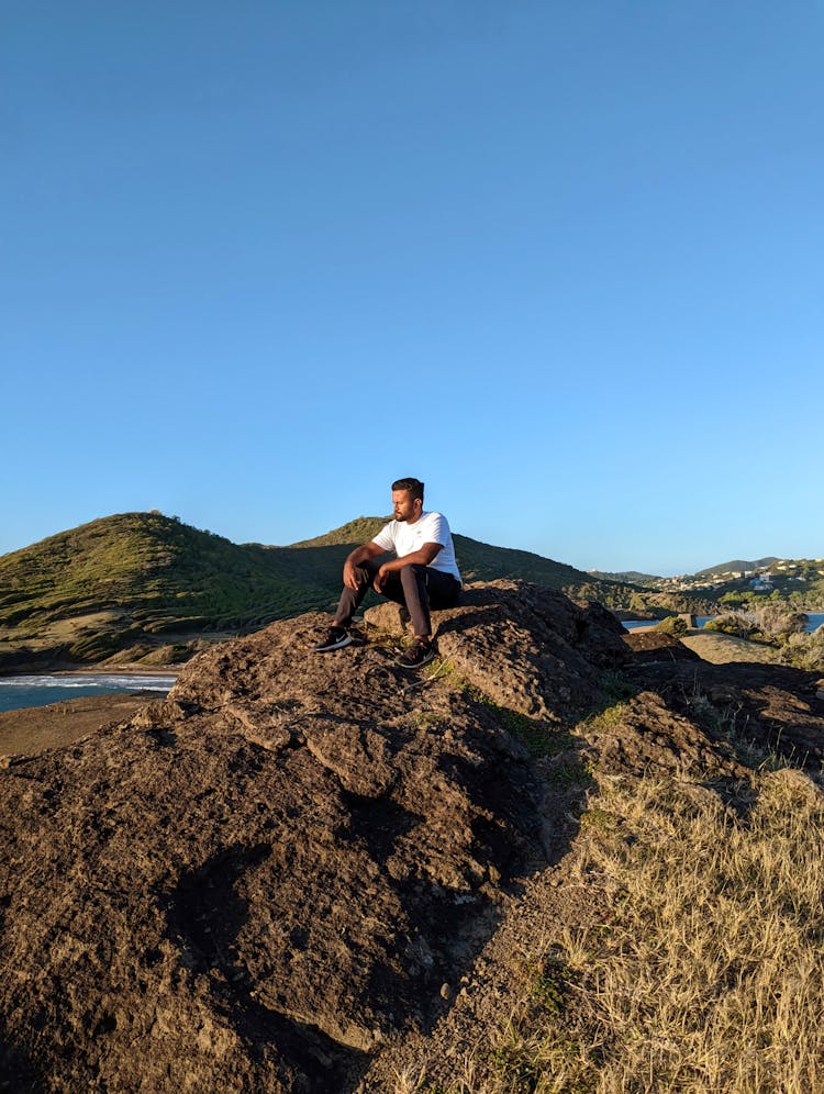 Man Sitting On A Rock