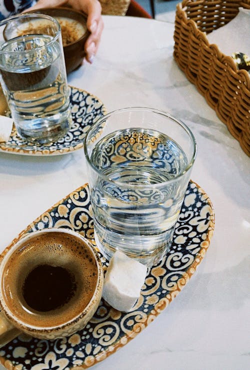 Free Cup of Coffee Beside a Glass of Water Stock Photo