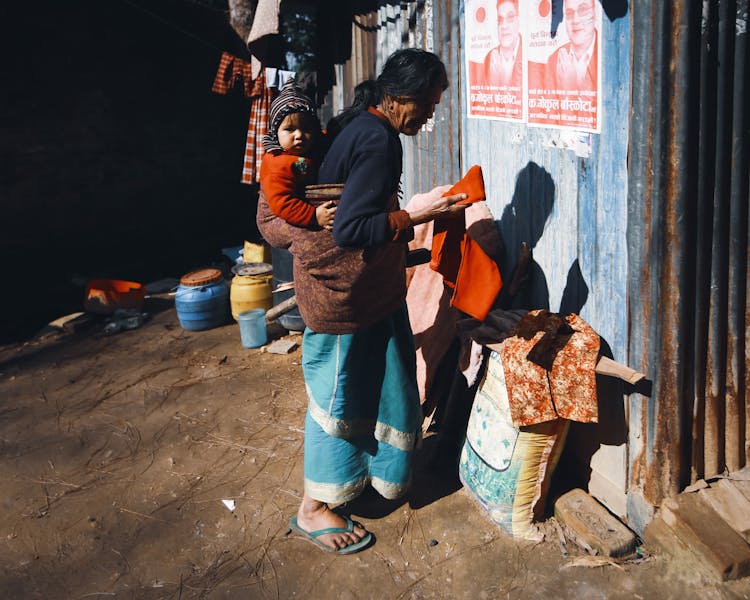 Woman Carrying A Child On The Back