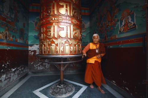 Senior Monk Standing in an Ornamental Interior