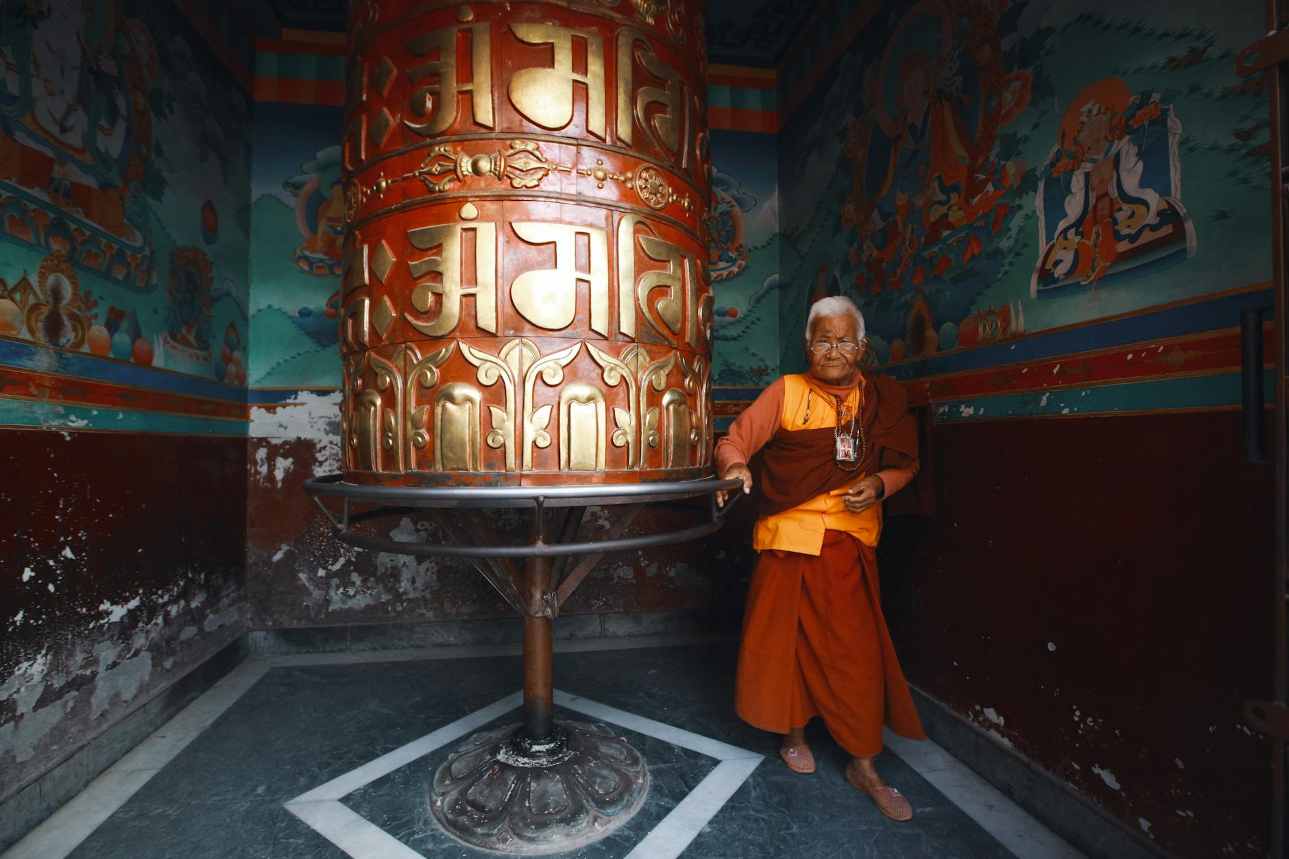 Senior Monk Standing in an Ornamental Interior