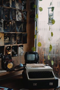 Cozy retro workspace with a vintage typewriter and nostalgic photo wall.