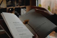 A Person Holding a Book with Yellow Flower