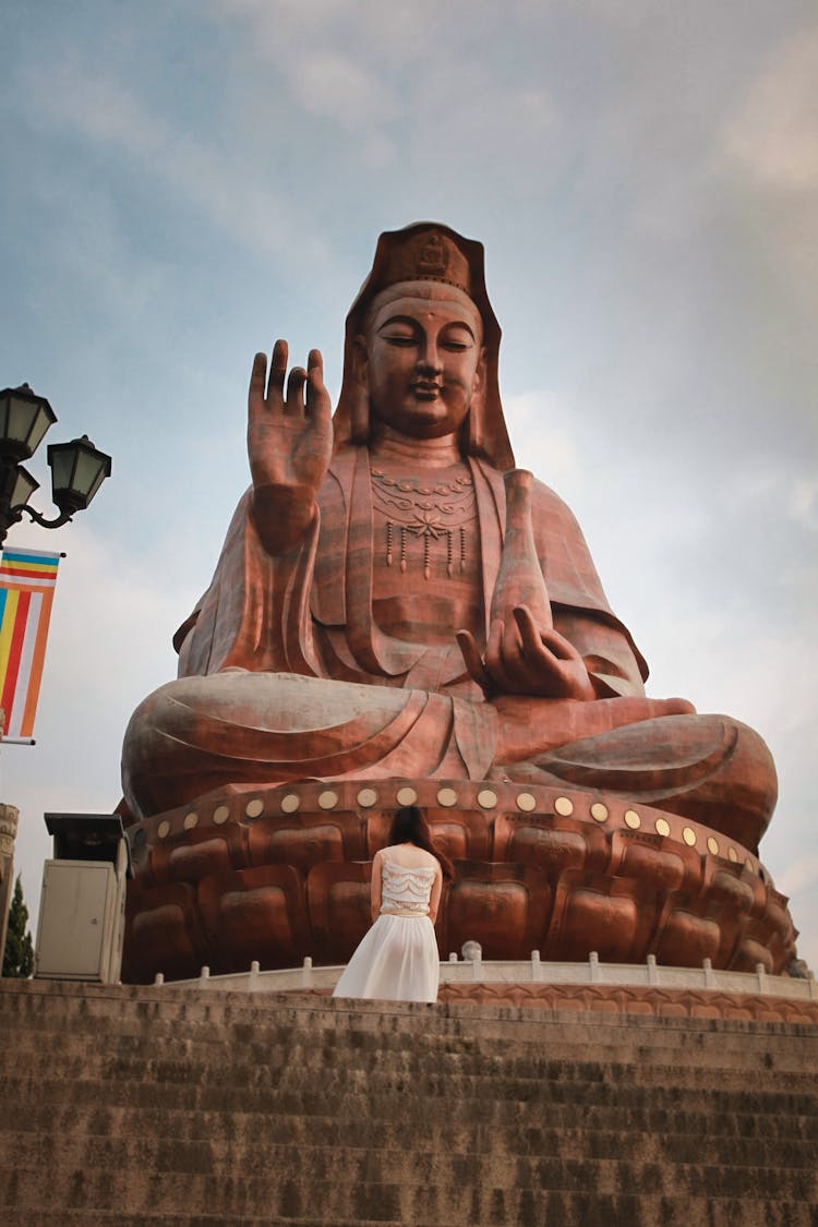 Person Standing On Colossal Guanyin Statue