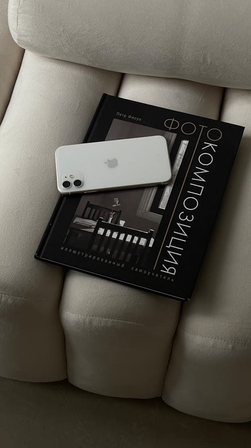 White Smartphone on Black Book