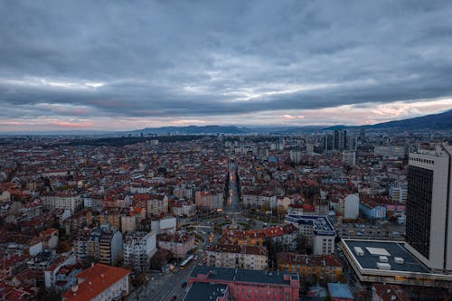 Aerial Shot of City Buildings Under the Cloudy Sky 