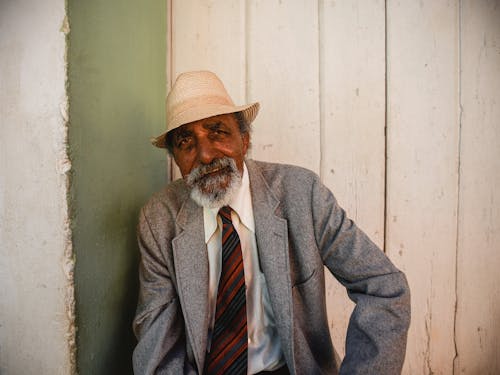 A Man in Gray Coat Wearing a Straw Hat