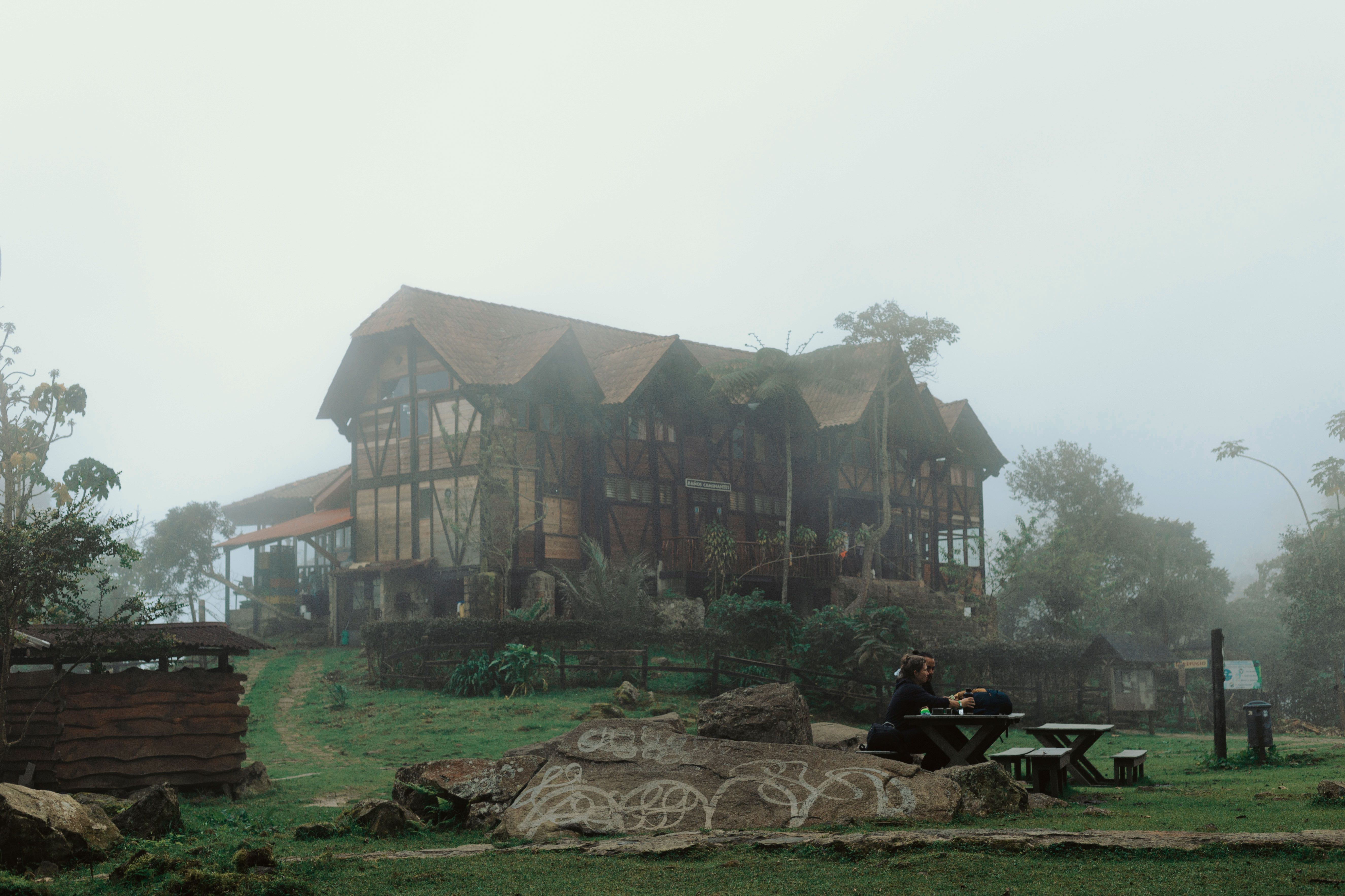 Mist surrounds a wooden building in San Antonio del Tequendama, creating a serene, foggy atmosphere. - San Agustín