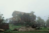 Mist surrounds a wooden building in San Antonio del Tequendama, creating a serene, foggy atmosphere.