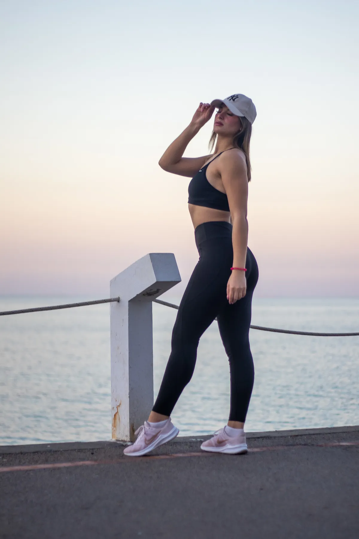 Woman in sporty attire by the sea