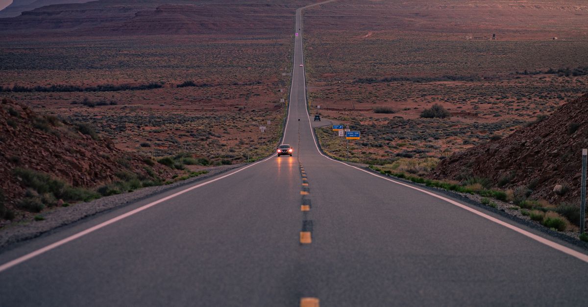 Rüyada Angelina Jolie ile Yolculuk Yapmak - Rüya Tabiri ve Anlamı - Dramatic road leading to Monument Valley with a stunning sunset sky.