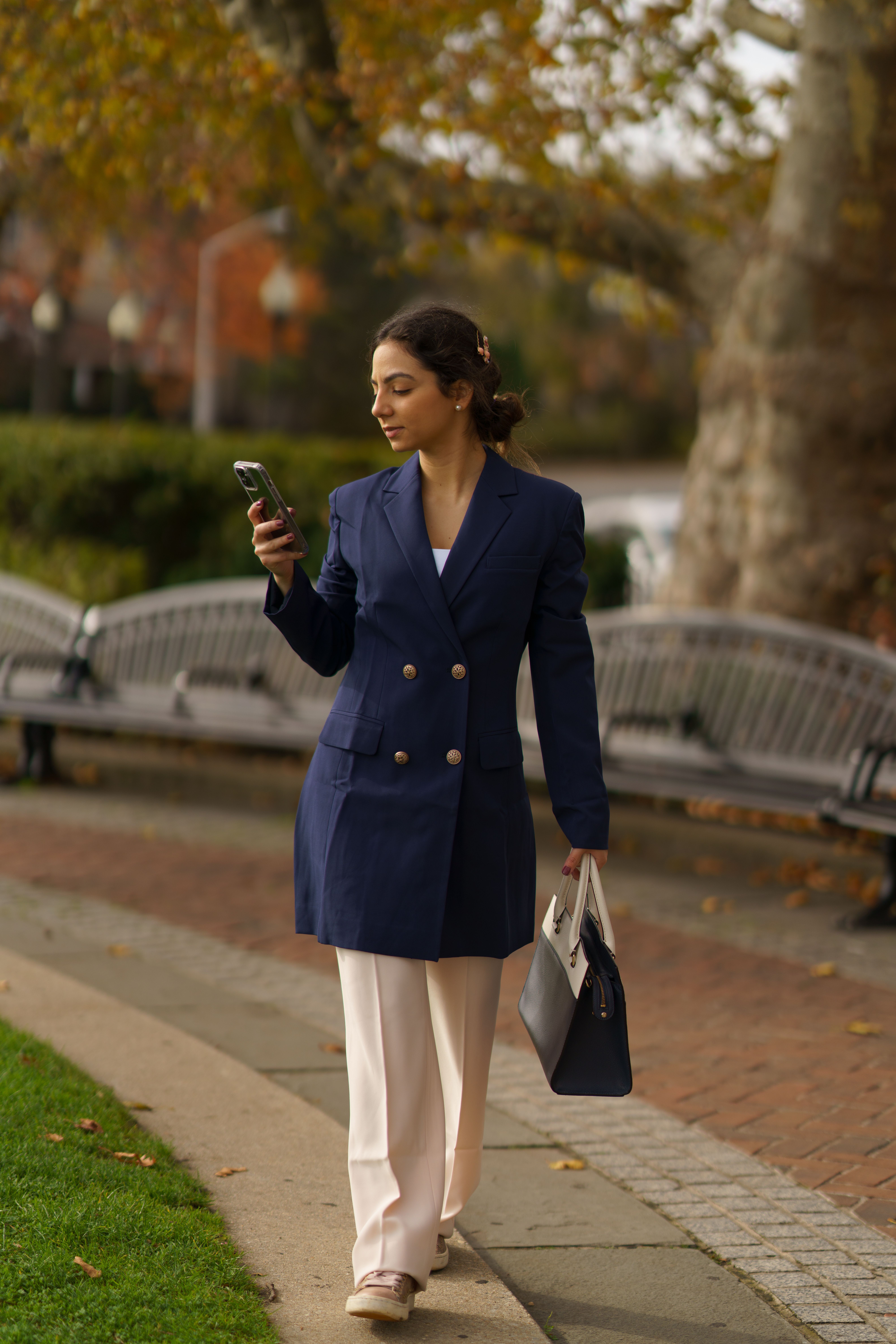 A Woman in Blue Coat Holding a Smartphone · Free Stock Photo