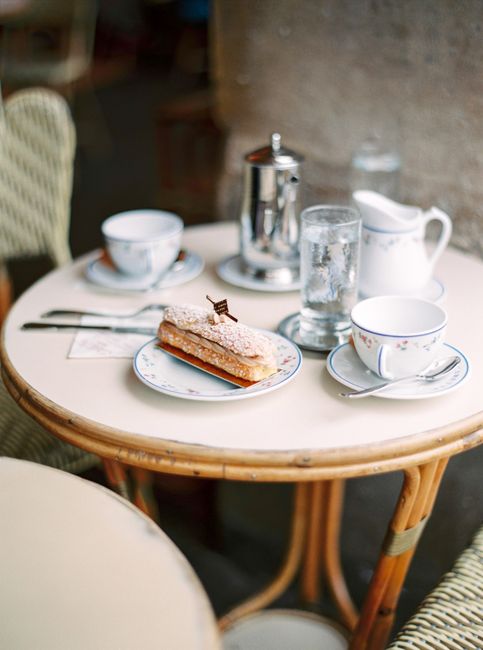 Charming café table with a delicious pastry and fine china, creating a cozy dining atmosphere.