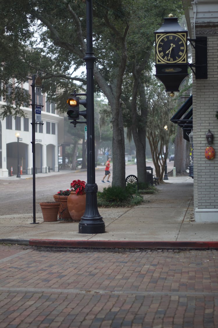 Stoplight In Front Of A Street Clock