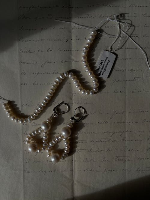 Pearl Accessories on Top of a Letter