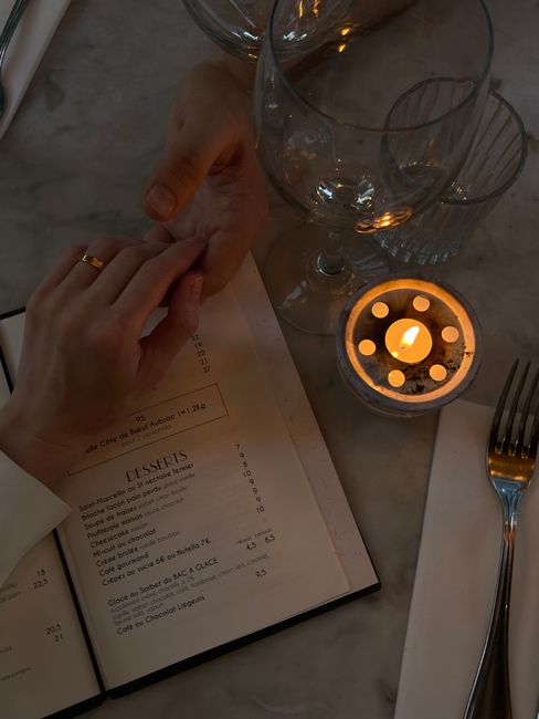 Intimate dining scene with candlelight and hands held, perfect for romantic themes.