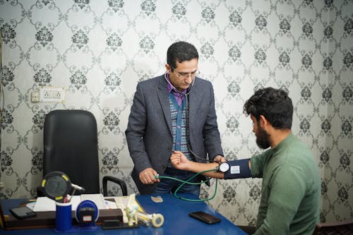 A Doctor Taking a Patient's Blood Pressure