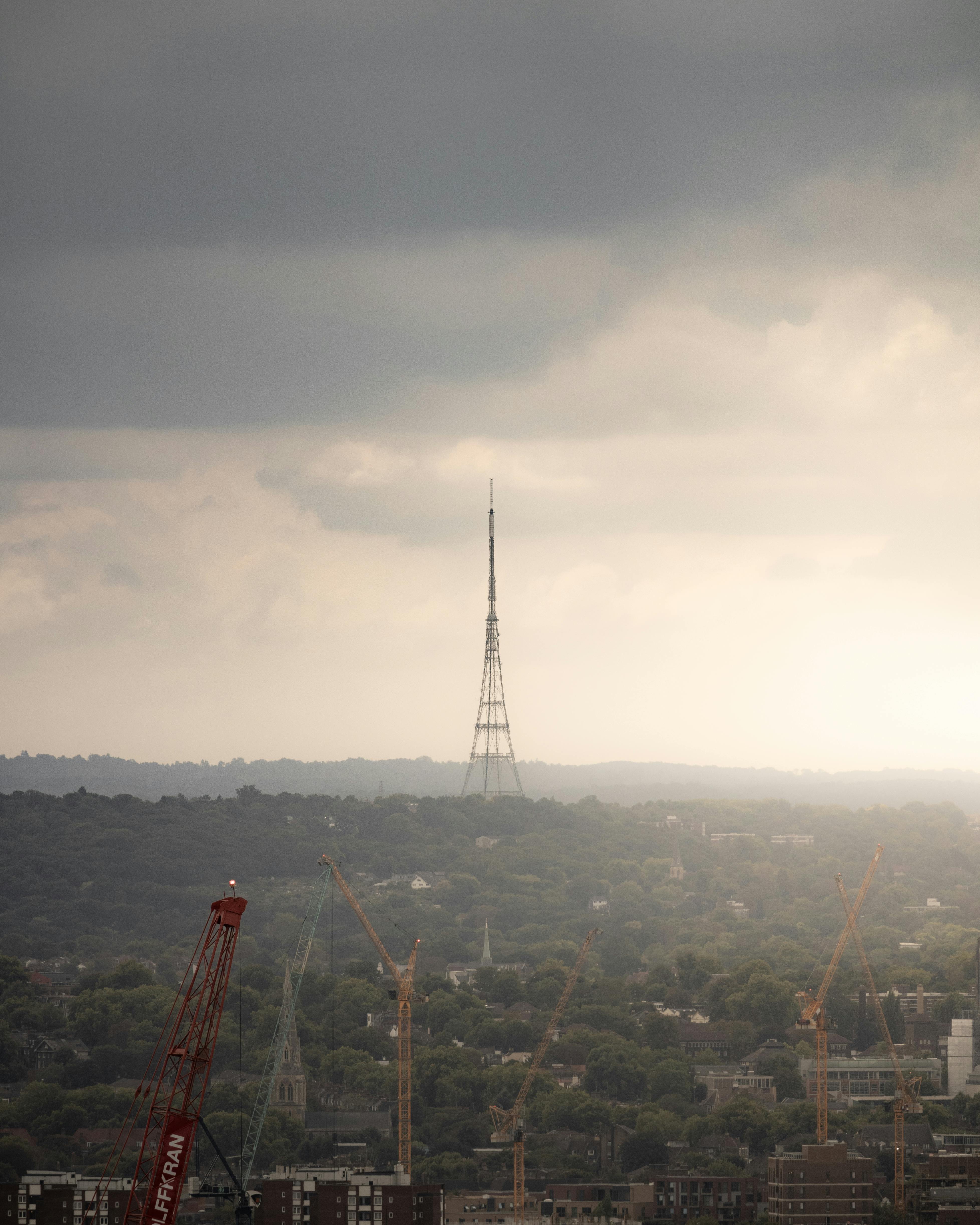 red and white crane on top of the hill