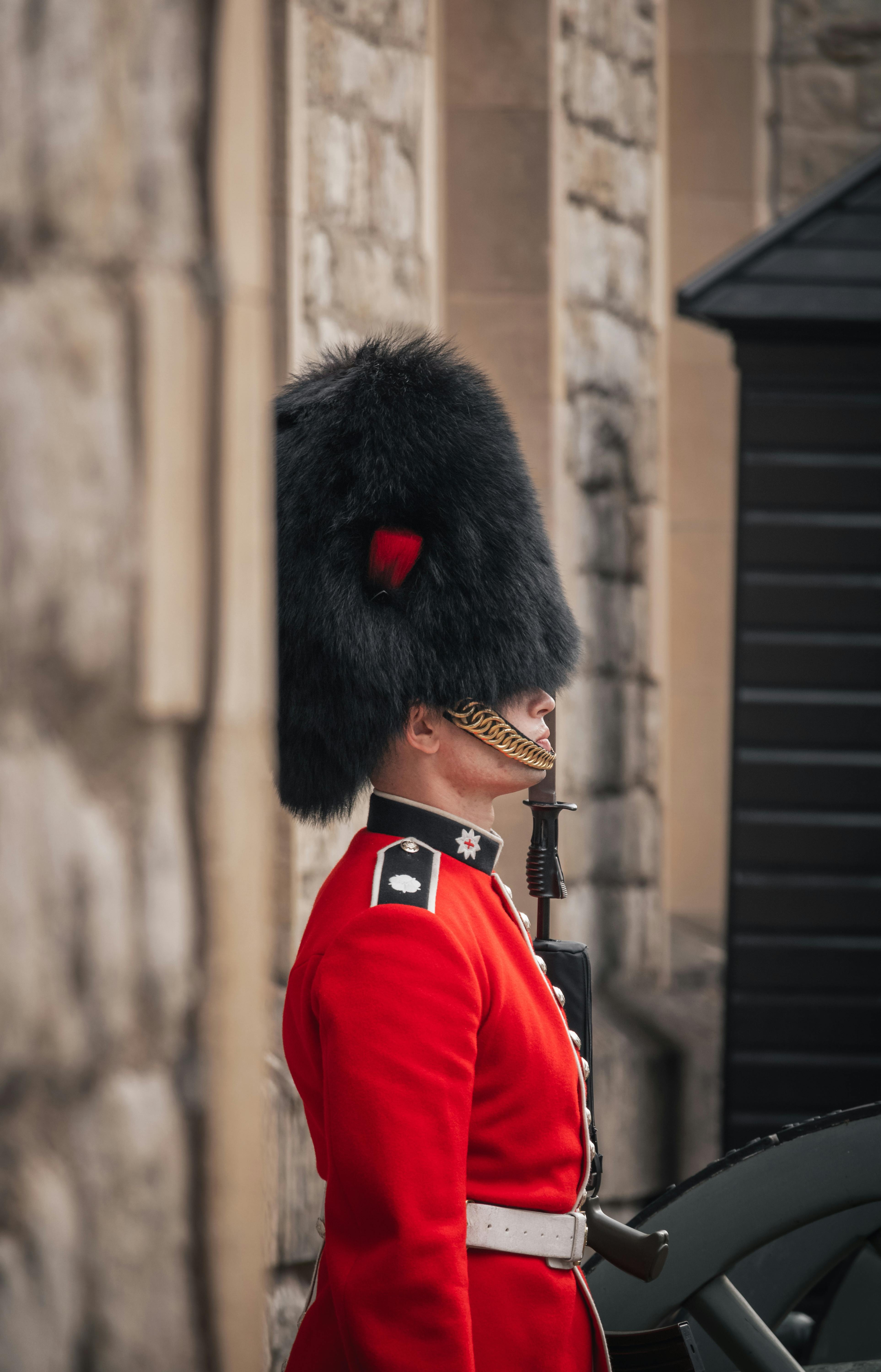 person in red coat wearing black hat